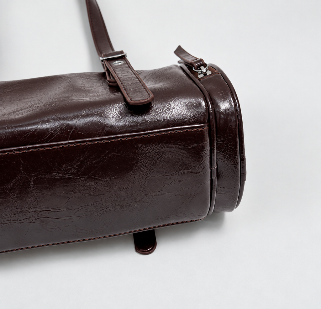 Barrel Shoulder Bag with Sleek Zippers and Buckle Accents