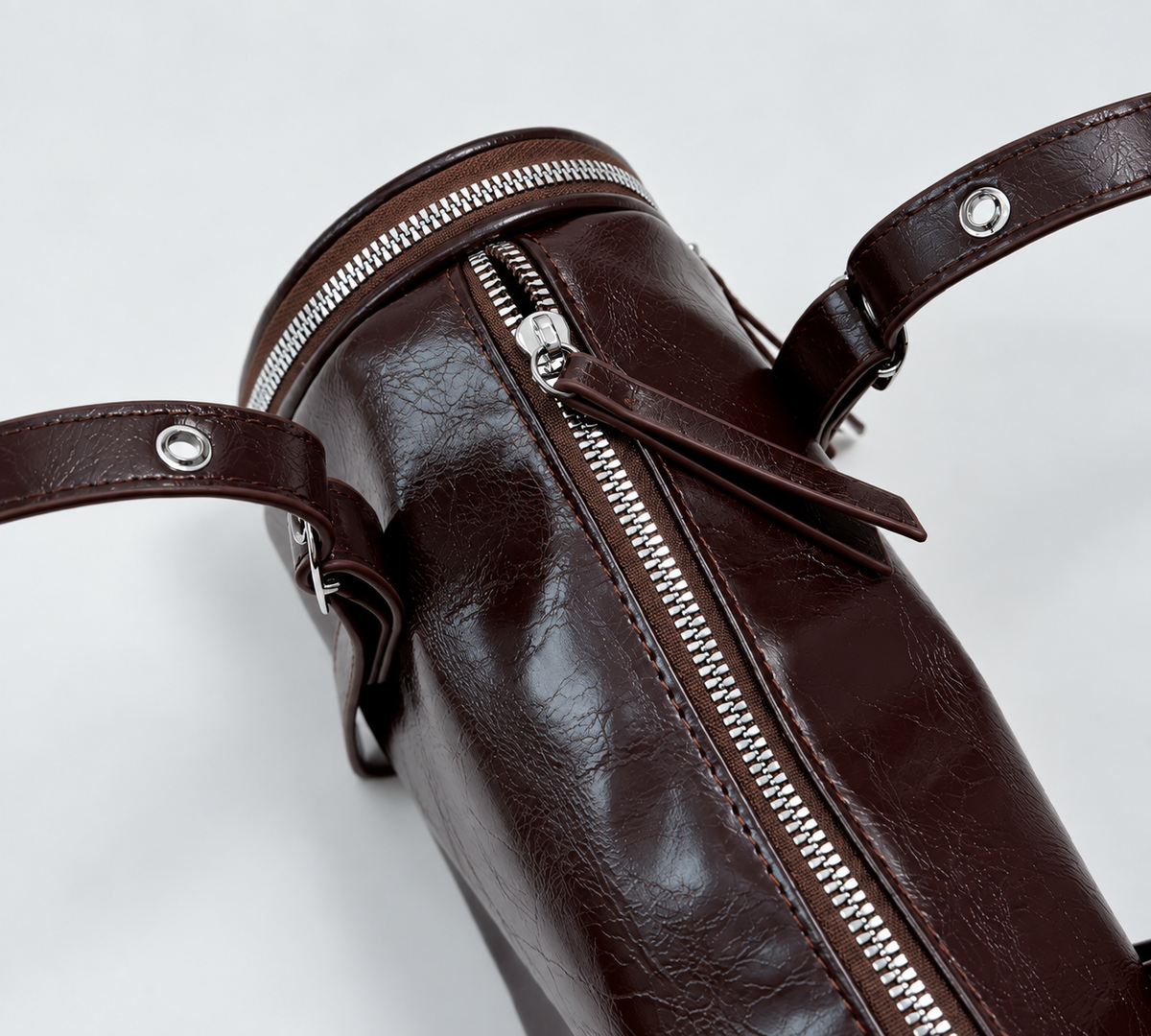 Barrel Shoulder Bag with Sleek Zippers and Buckle Accents